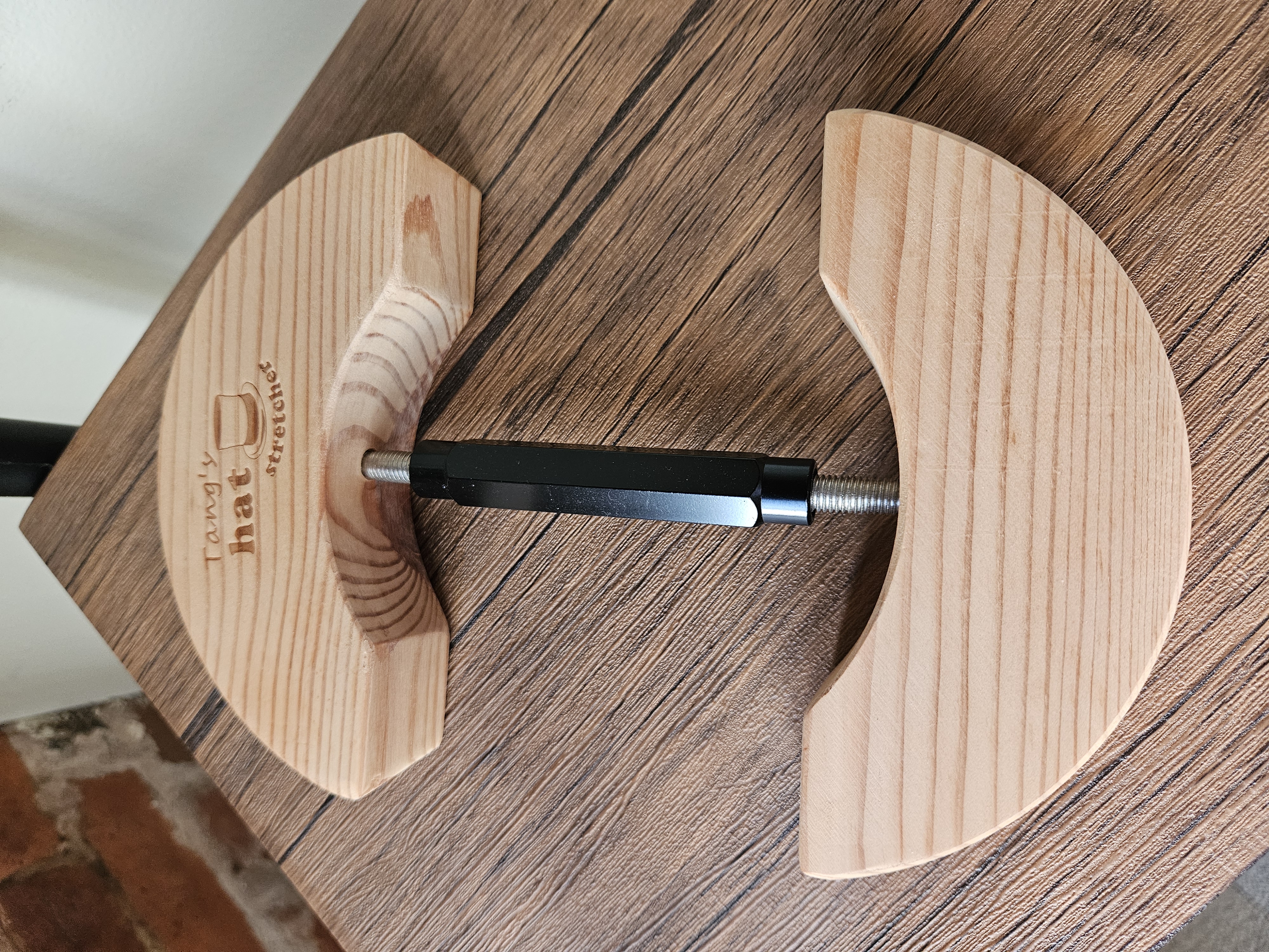 Tang's wooden hat stretcher on a wood surface